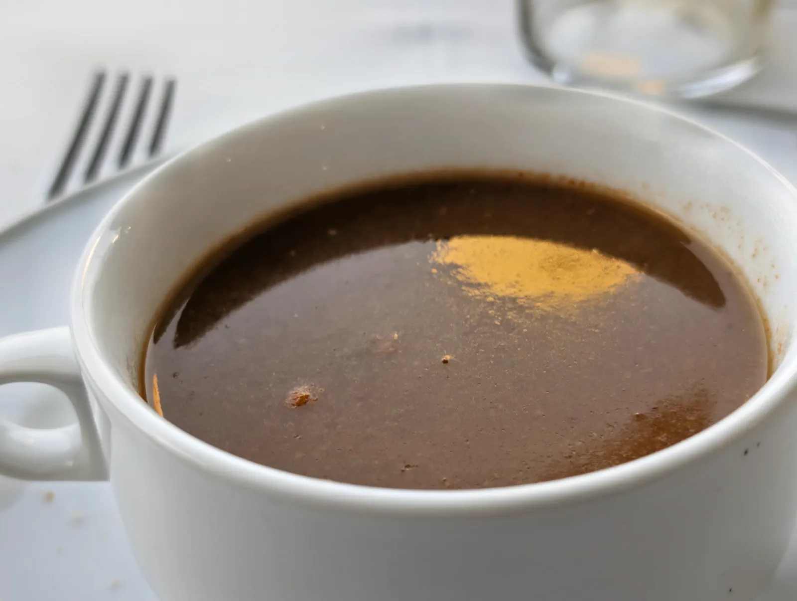 Taza de crema de pescados y mariscos humeante servida en el Asador Alaia